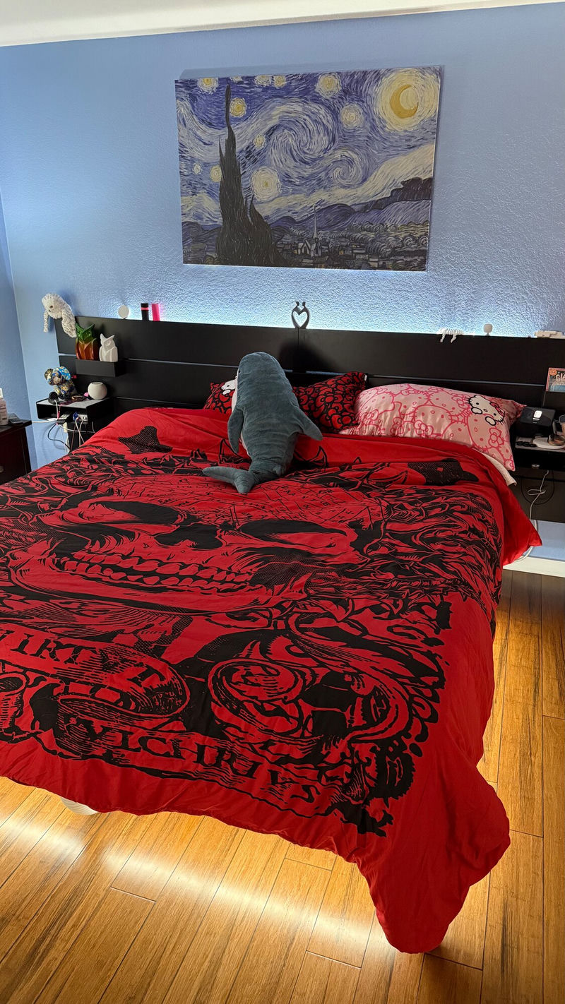 A picture showing a king-size bed that is made up showcasing the underbed lighting from the Philips Hue Lightstrip